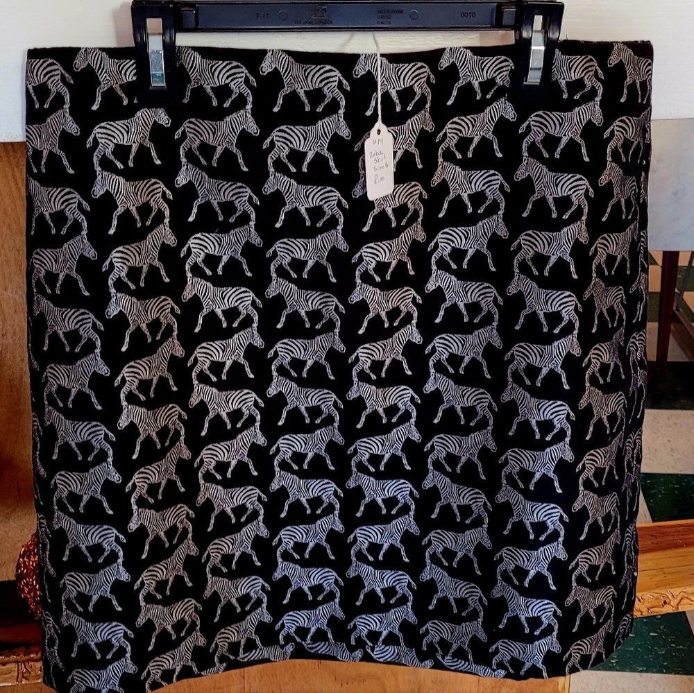 Skirt, black with silver zebras. Above the knee length. Size 6.